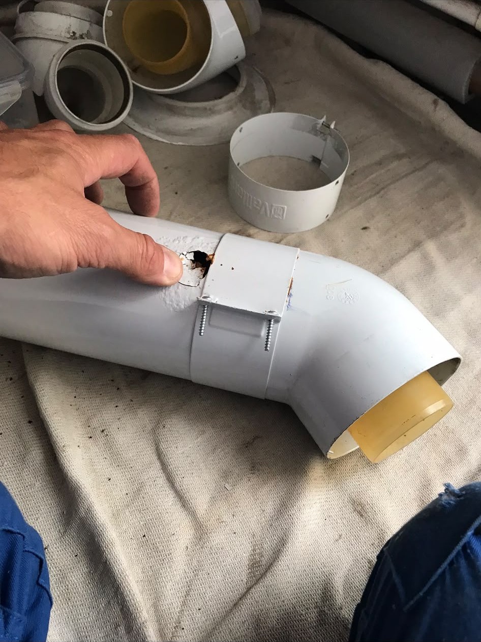 Rusted-through boiler flue elbow found on a London repair visit