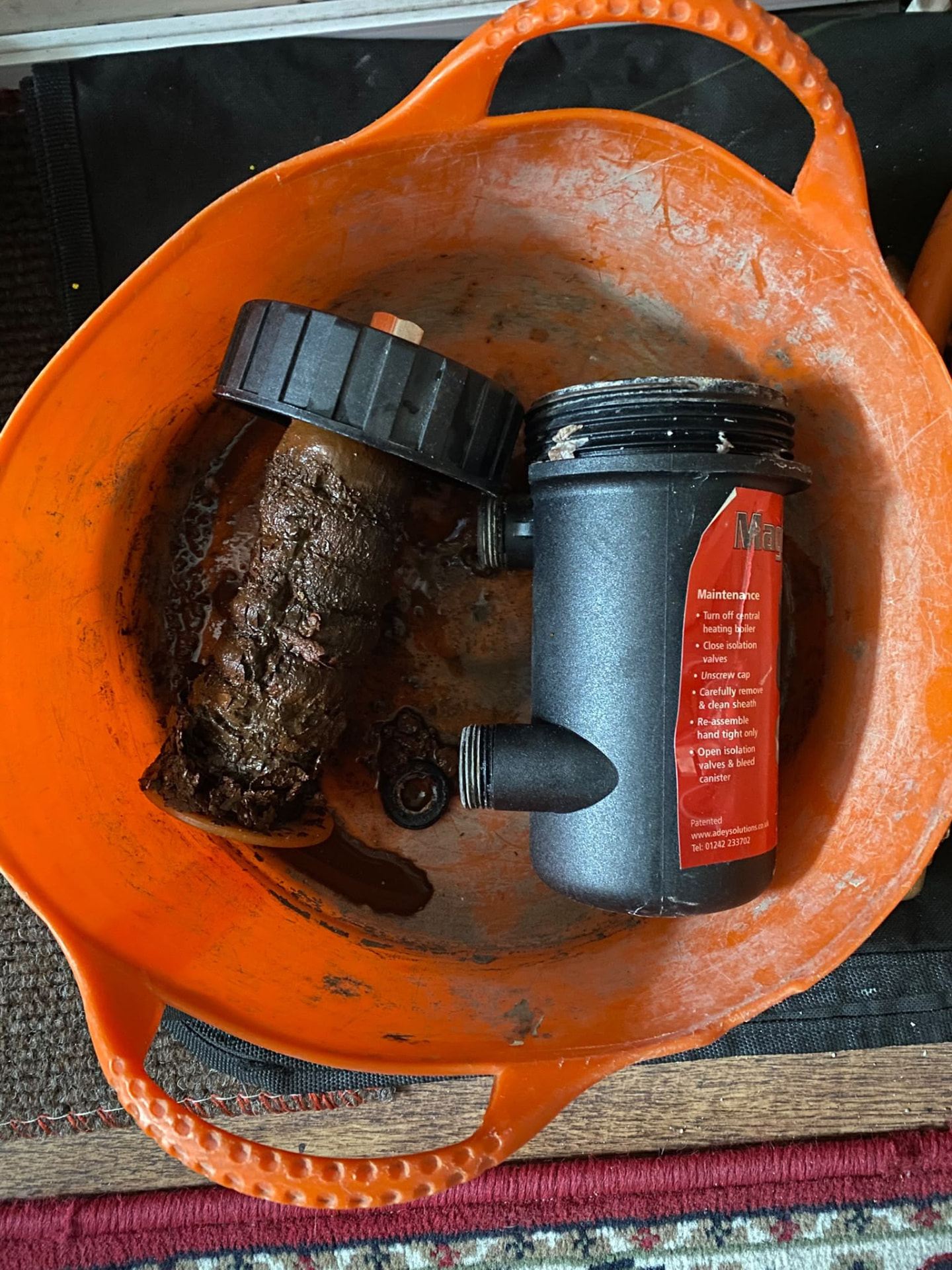 Magnetic filter core coated in magnetite sludge captured during a London powerflush