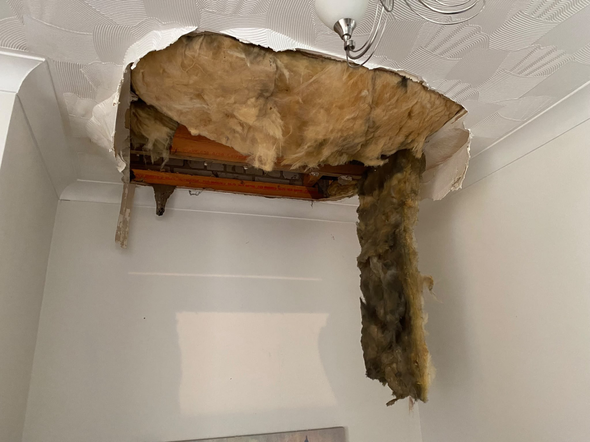 Ceiling damage from a water leak in a London property prior to plumbing repair