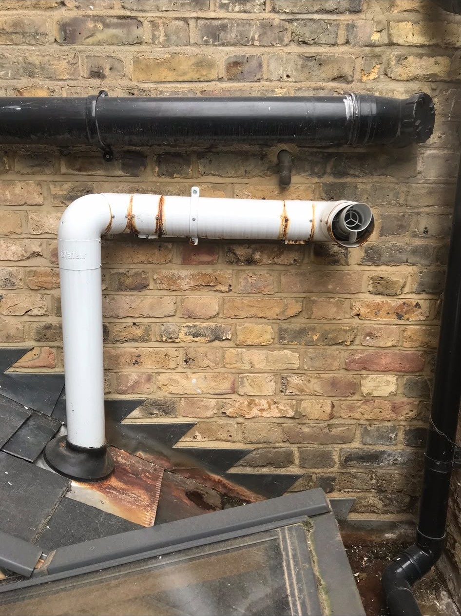 Corroded boiler flue pipe identified during a London repair